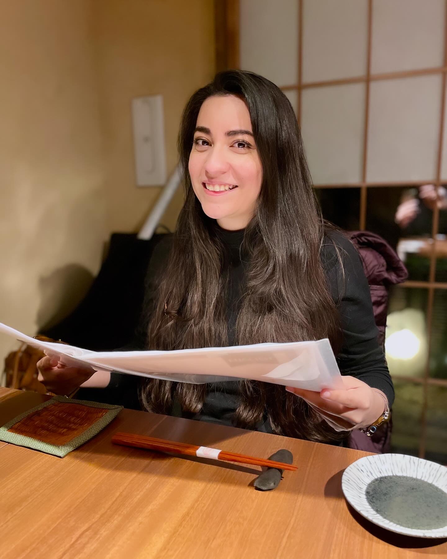 Aileen smiling at a restaurant